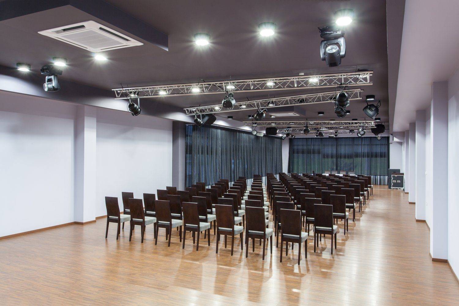 Pusta sala konferencyjna ze sceną i rzędami krzeseł